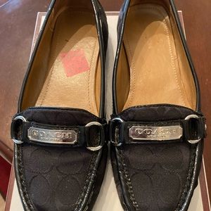 Coach Signature C’s Black with silver hardware loafers.